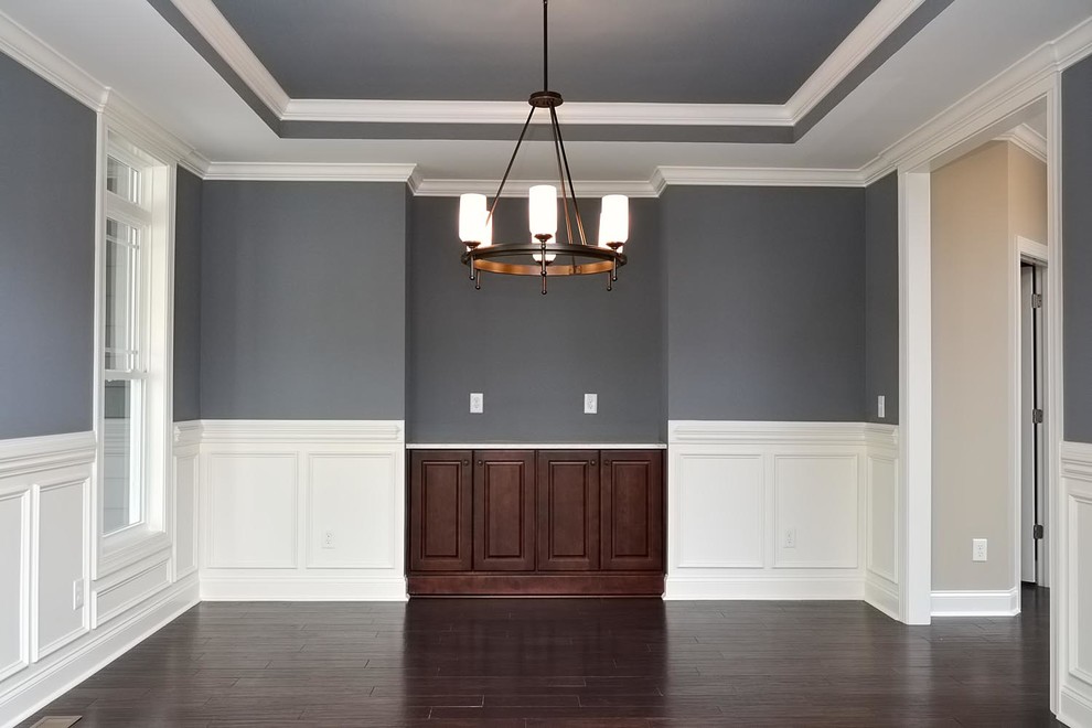 This is an example of a large arts and crafts separate dining room in Raleigh with grey walls, dark hardwood floors and no fireplace.