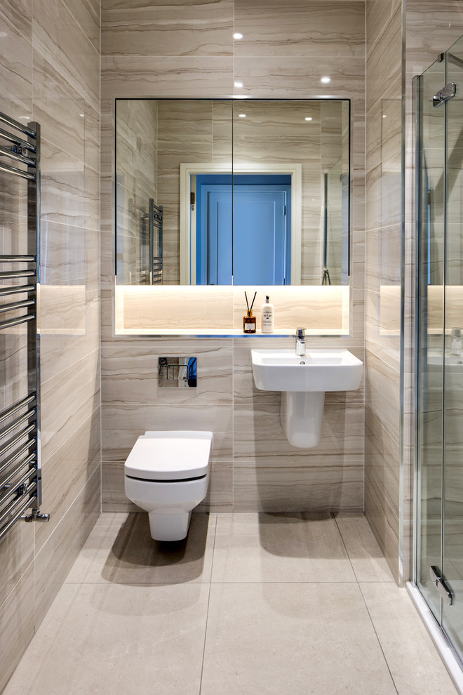 Mid-sized contemporary 3/4 bathroom in Dublin with a wall-mount toilet, beige tile, porcelain tile, beige walls, porcelain floors, beige floor, an alcove shower, a wall-mount sink and a hinged shower door.
