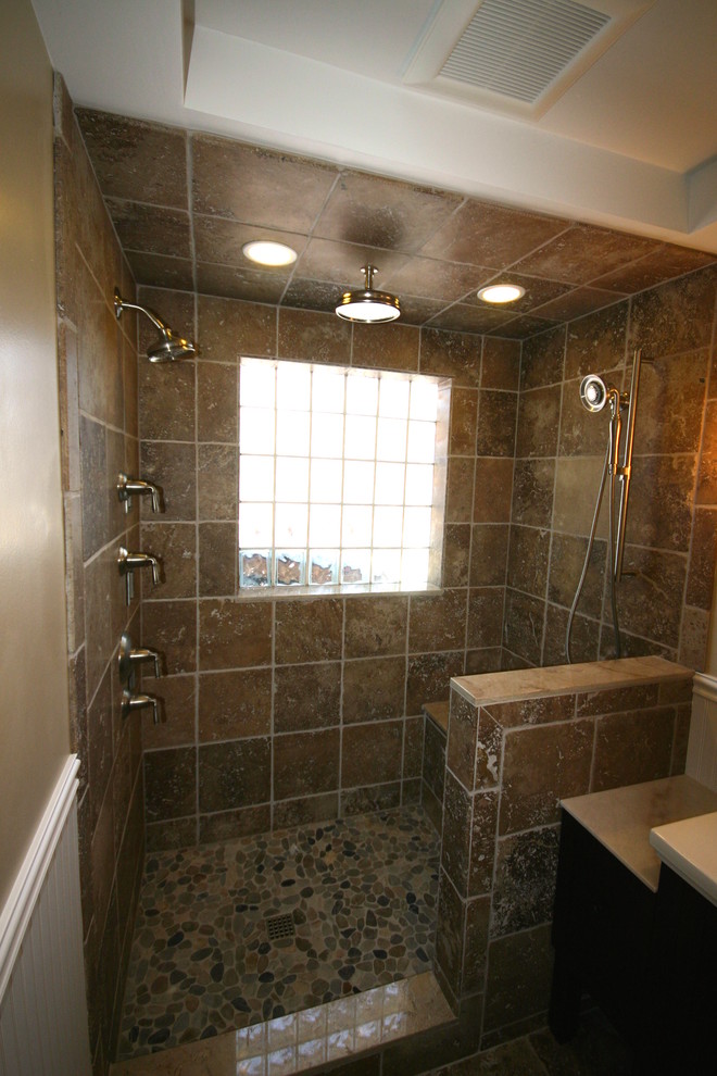 Design ideas for a mid-sized traditional 3/4 bathroom in Salt Lake City with a console sink, furniture-like cabinets, dark wood cabinets, marble benchtops, an open shower, a two-piece toilet, brown tile, stone tile, beige walls and travertine floors.