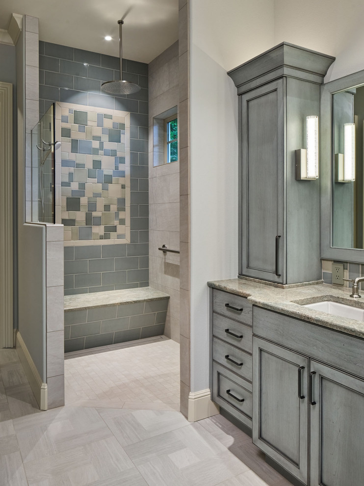 This is an example of a large transitional master bathroom in Portland with recessed-panel cabinets, blue cabinets, a freestanding tub, a curbless shower, multi-coloured tile, ceramic tile, porcelain floors, an undermount sink, granite benchtops, grey floor, an open shower, green benchtops, a shower seat, a double vanity and a built-in vanity.