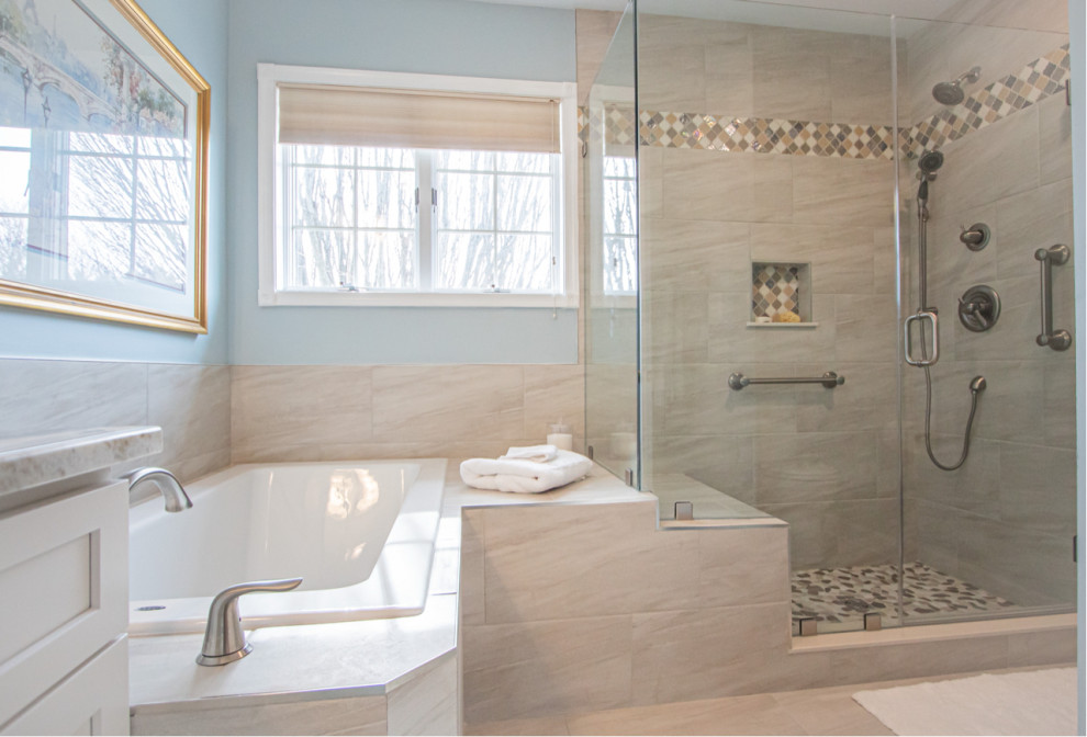 This is an example of a transitional master bathroom in Baltimore with white cabinets, a drop-in tub, a corner shower, a two-piece toilet, brown tile, porcelain tile, brown walls, porcelain floors, an undermount sink, granite benchtops, brown floor, a hinged shower door, brown benchtops, a shower seat, a single vanity and a built-in vanity.