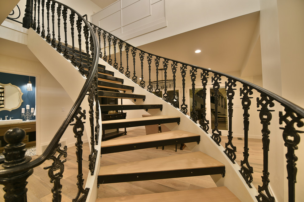 Inspiration for a mid-sized transitional wood curved staircase in Salt Lake City with metal railing.