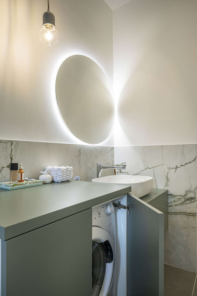 Photo of a small modern 3/4 bathroom in Milan with flat-panel cabinets, green cabinets, a curbless shower, a two-piece toilet, white tile, porcelain tile, white walls, porcelain floors, a vessel sink, wood benchtops, grey floor, a hinged shower door, green benchtops, a laundry, a single vanity and a floating vanity.