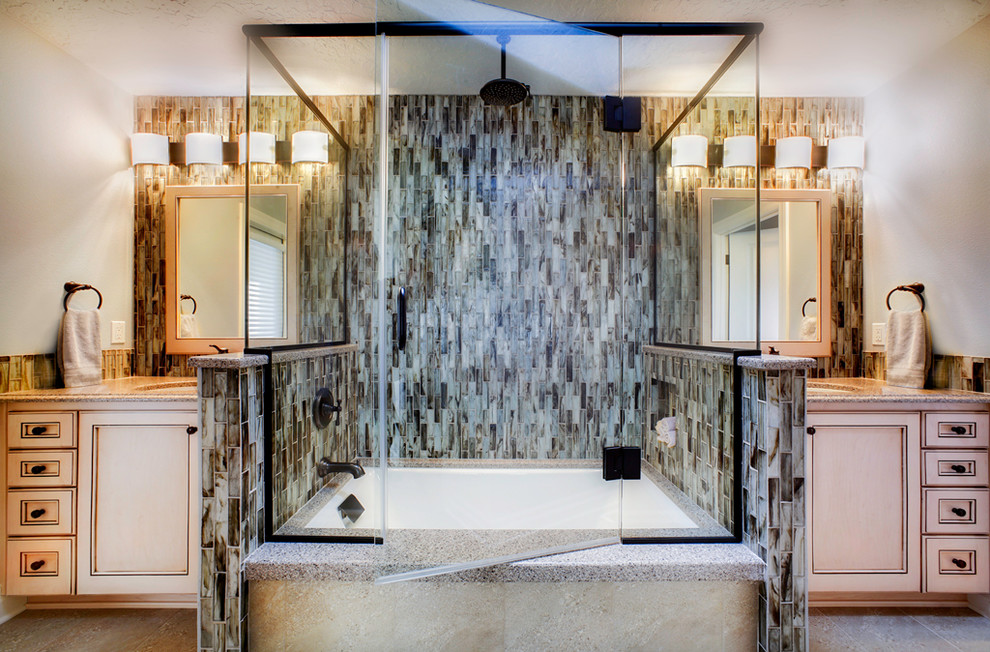 Inspiration for a mid-sized beach style master bathroom in Portland with light wood cabinets, an undermount tub, a shower/bathtub combo, multi-coloured tile, stone tile, beige walls, an undermount sink, granite benchtops and a hinged shower door.