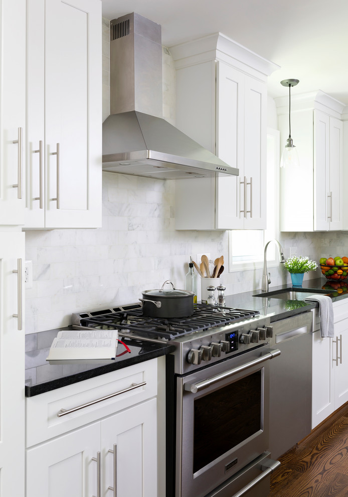 Inspiration for a large transitional l-shaped eat-in kitchen in DC Metro with white cabinets, grey splashback, marble splashback, stainless steel appliances, medium hardwood floors and with island.