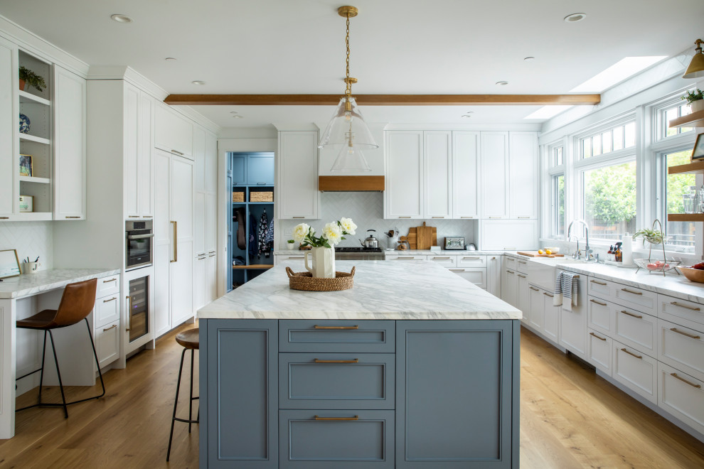 Large farmhouse medium tone wood floor kitchen photo in San Francisco with marble countertops, stainless steel appliances, an island, multicolored countertops, a farmhouse sink, shaker cabinets, white cabinets, white backsplash and ceramic backsplash