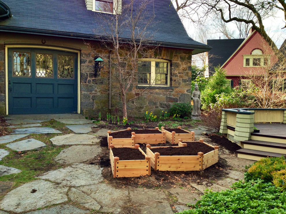 Photo of a small traditional courtyard partial sun garden for summer in Boston with a vegetable garden and natural stone pavers.
