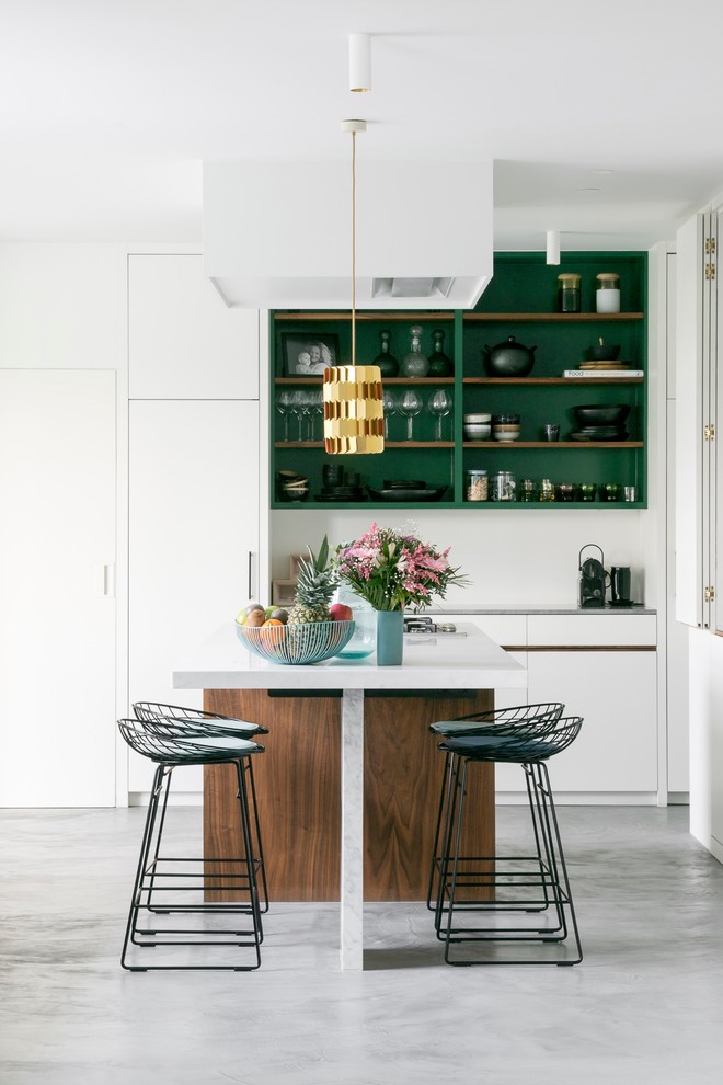 Mid-sized contemporary l-shaped eat-in kitchen in Other with a double-bowl sink, white cabinets, marble benchtops, concrete floors, grey floor, white benchtop, flat-panel cabinets, white splashback, panelled appliances and with island.
