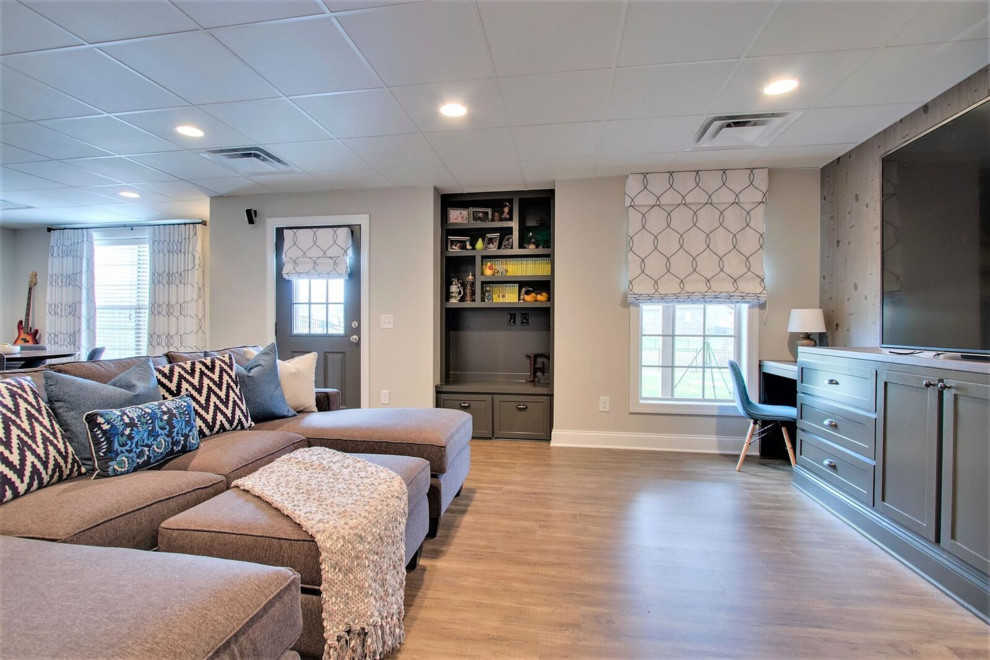 Photo of a large transitional walk-out basement in Nashville with white walls, medium hardwood floors and brown floor.