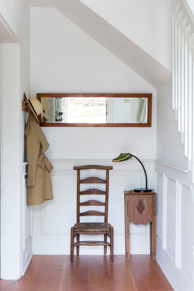 Design ideas for a small country hallway in Portland with white walls and medium hardwood floors.