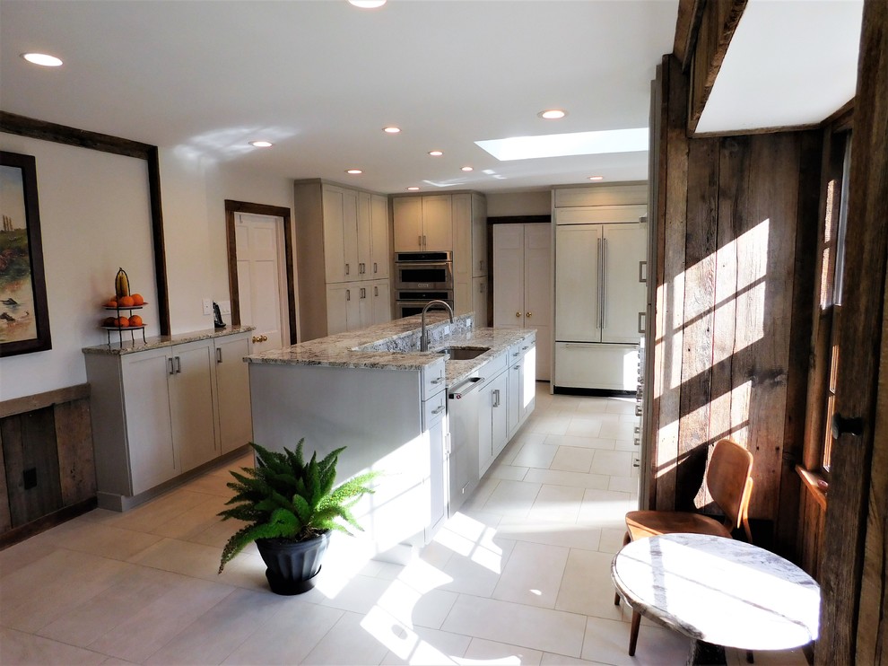 Open concept kitchen - mid-sized transitional u-shaped ceramic tile and white floor open concept kitchen idea in DC Metro with an undermount sink, recessed-panel cabinets, white cabinets, marble countertops, stainless steel appliances and an island