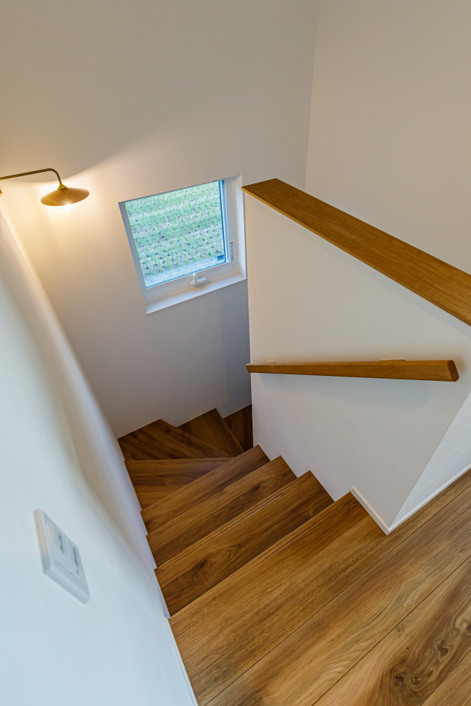 Источник вдохновения для домашнего уюта: угловая деревянная лестница среднего размера в восточном стиле с деревянными ступенями, деревянными перилами и обоями на стенах
