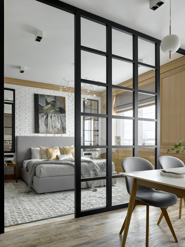 Design ideas for a contemporary master bedroom in Moscow with beige floor and brick walls.