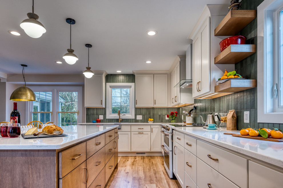 Example of a large transitional kitchen design in DC Metro with flat-panel cabinets, white cabinets, quartz countertops, green backsplash, ceramic backsplash, an island and white countertops