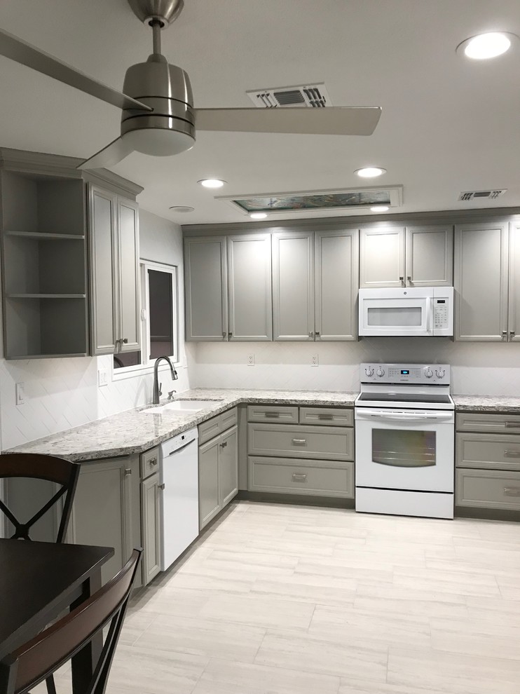 Design ideas for a mid-sized contemporary l-shaped eat-in kitchen in Phoenix with an undermount sink, flat-panel cabinets, grey cabinets, quartz benchtops, white splashback, subway tile splashback, white appliances, porcelain floors, no island and grey floor.