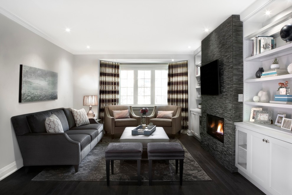 Inspiration for a mid-sized contemporary enclosed family room in Toronto with grey walls, dark hardwood floors, a ribbon fireplace, a tile fireplace surround, a wall-mounted tv and brown floor.