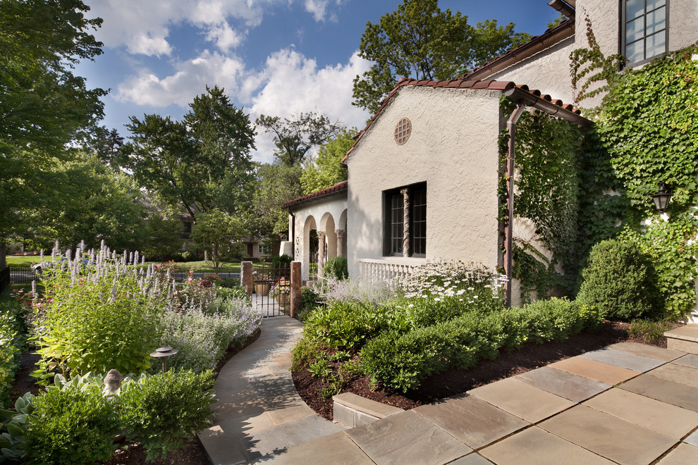 Design ideas for a mid-sized mediterranean front yard garden in DC Metro with a garden path and natural stone pavers.