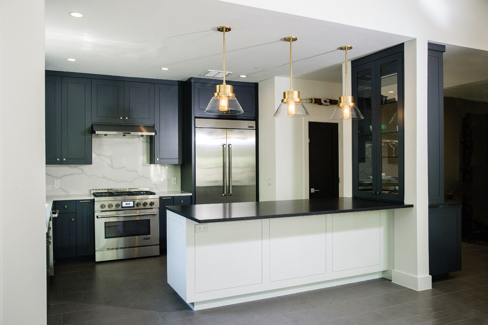 Example of a mid-sized transitional l-shaped cement tile floor and gray floor eat-in kitchen design in Austin with an undermount sink, flat-panel cabinets, blue cabinets, quartz countertops, white backsplash, stainless steel appliances, an island and white countertops