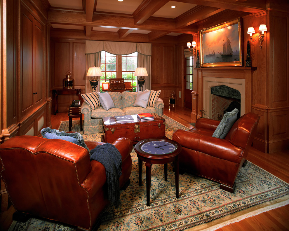 This is an example of a large traditional study room in Boston with medium hardwood floors, a standard fireplace and a freestanding desk.