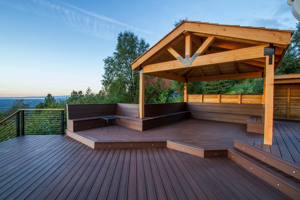 Inspiration for an expansive country backyard deck in Other with a fire feature and a pergola.
