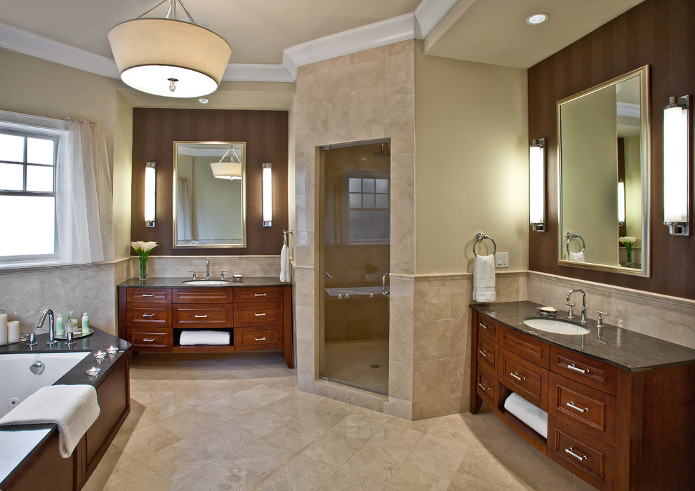 Photo of an expansive traditional master bathroom in Chicago with a corner shower, an undermount sink, recessed-panel cabinets, medium wood cabinets, limestone benchtops, an undermount tub, a two-piece toilet, beige tile, stone tile, beige walls and marble floors.