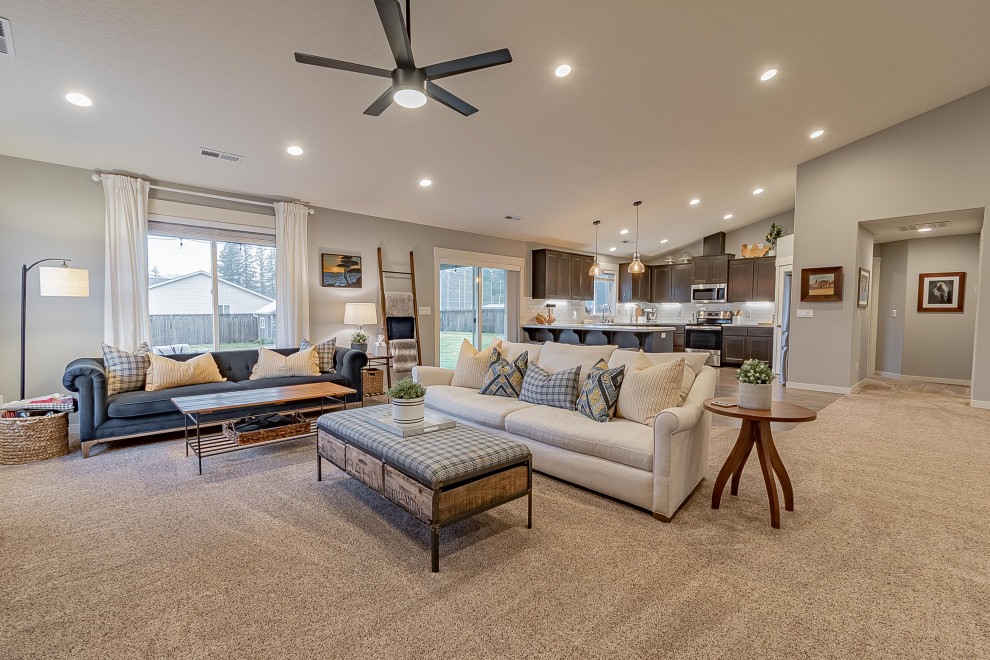 This is an example of a mid-sized eclectic open concept family room in Portland with grey walls, carpet, beige floor and vaulted.