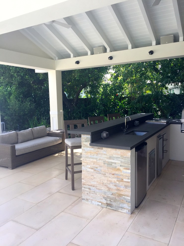 Inspiration for a mid-sized contemporary backyard patio in Miami with an outdoor kitchen, concrete pavers and a pergola.