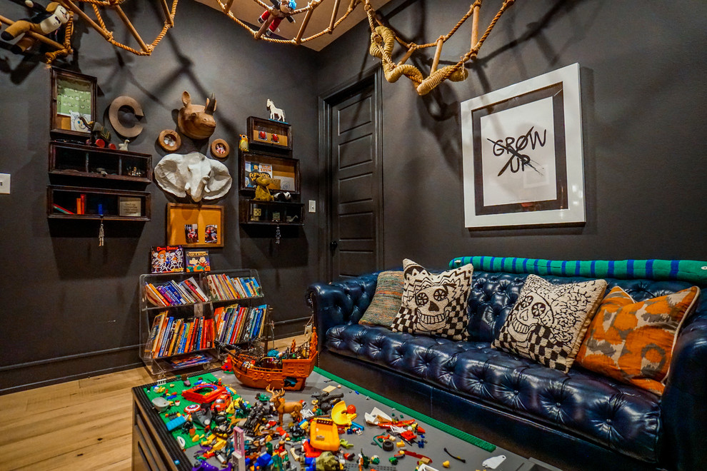 Mid-sized eclectic gender-neutral kids' playroom in Austin with black walls, medium hardwood floors and brown floor for kids 4-10 years old.