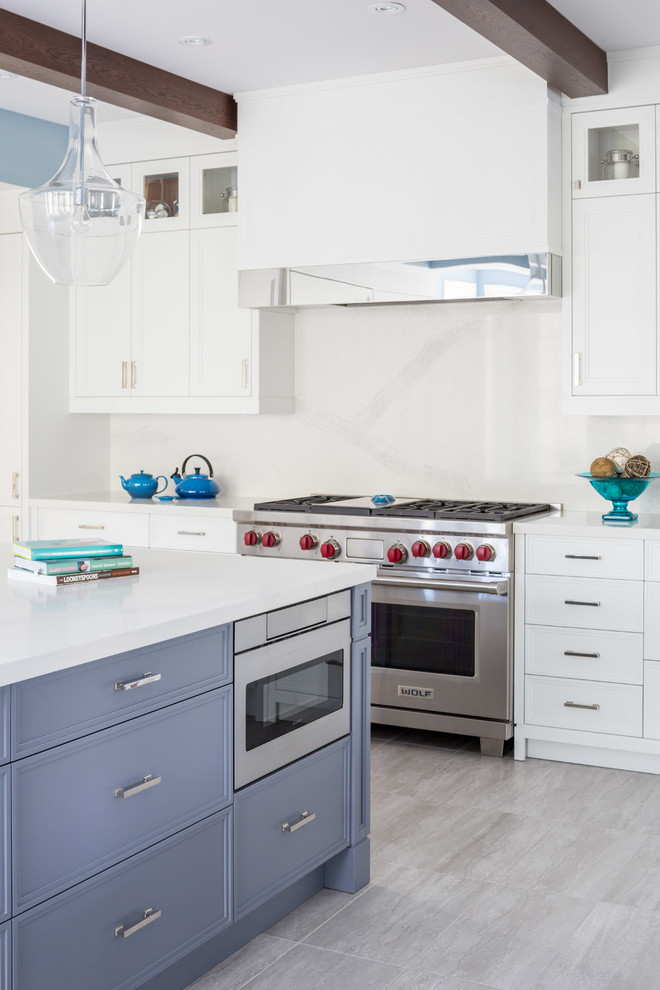 Inspiration for a mid-sized transitional galley separate kitchen in Toronto with an undermount sink, shaker cabinets, white cabinets, limestone benchtops, white splashback, cement tile splashback, stainless steel appliances, medium hardwood floors and with island.