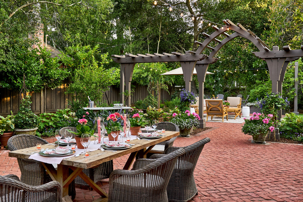 Photo of an expansive traditional backyard patio in San Francisco with brick pavers and no cover.