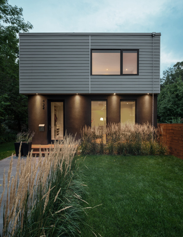 Design ideas for a mid-sized contemporary two-storey grey exterior in Toronto with mixed siding and a flat roof.