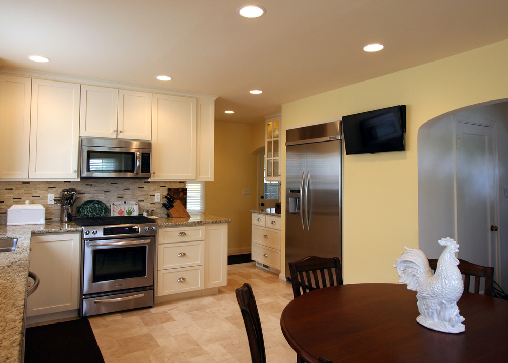 Example of a mid-sized transitional single-wall ceramic tile eat-in kitchen design with an undermount sink, shaker cabinets, white cabinets, granite countertops, beige backsplash, stone tile backsplash, stainless steel appliances and no island