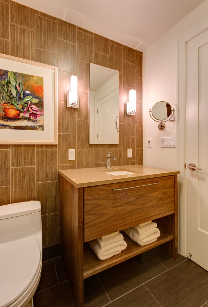 This is an example of a small contemporary 3/4 bathroom in Portland with an undermount sink, furniture-like cabinets, medium wood cabinets, engineered quartz benchtops, an alcove shower, a one-piece toilet, brown tile, porcelain tile, white walls and porcelain floors.