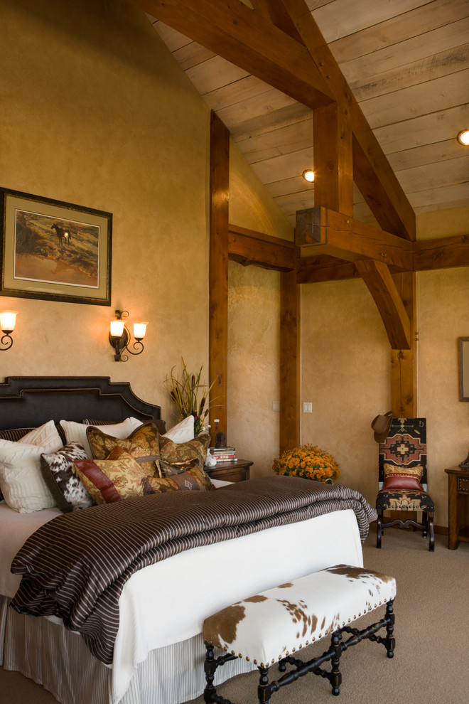 Photo of a country bedroom in Denver with beige walls and carpet.