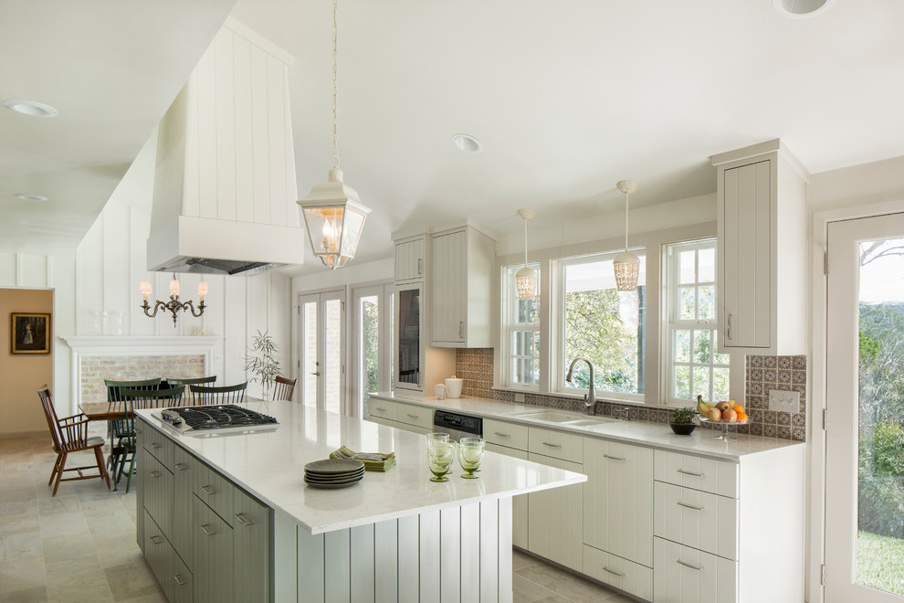 Mid-sized traditional galley eat-in kitchen in Austin with a double-bowl sink, white cabinets, quartz benchtops, ceramic splashback, stainless steel appliances, porcelain floors, with island, flat-panel cabinets and grey splashback.