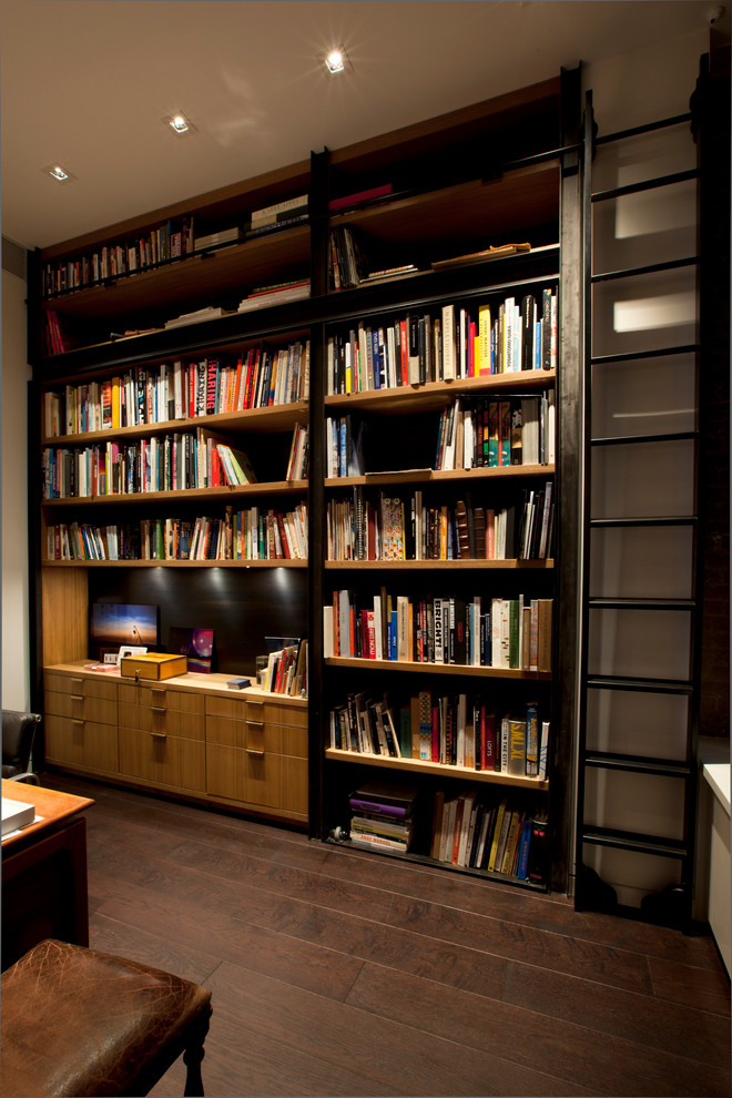 Photo of a mid-sized contemporary home office in New York with a library, dark hardwood floors and brown floor.