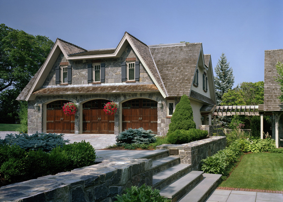 This is an example of a mid-sized traditional detached three-car garage in Boston.