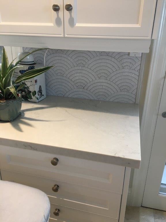 Inspiration for a mid-sized transitional l-shaped travertine floor and beige floor eat-in kitchen remodel in Orange County with recessed-panel cabinets, white cabinets, soapstone countertops, multicolored backsplash and mosaic tile backsplash