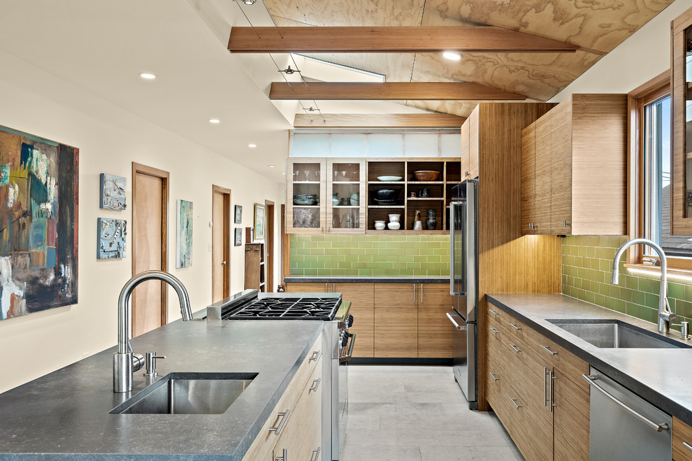 Eat-in kitchen - large contemporary l-shaped porcelain tile and gray floor eat-in kitchen idea in San Francisco with an undermount sink, flat-panel cabinets, medium tone wood cabinets, quartz countertops, green backsplash, ceramic backsplash, stainless steel appliances, an island and black countertops