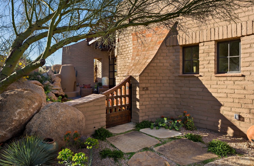Inspiration for a mid-sized backyard patio in Phoenix with natural stone pavers, a fire feature and a roof extension.