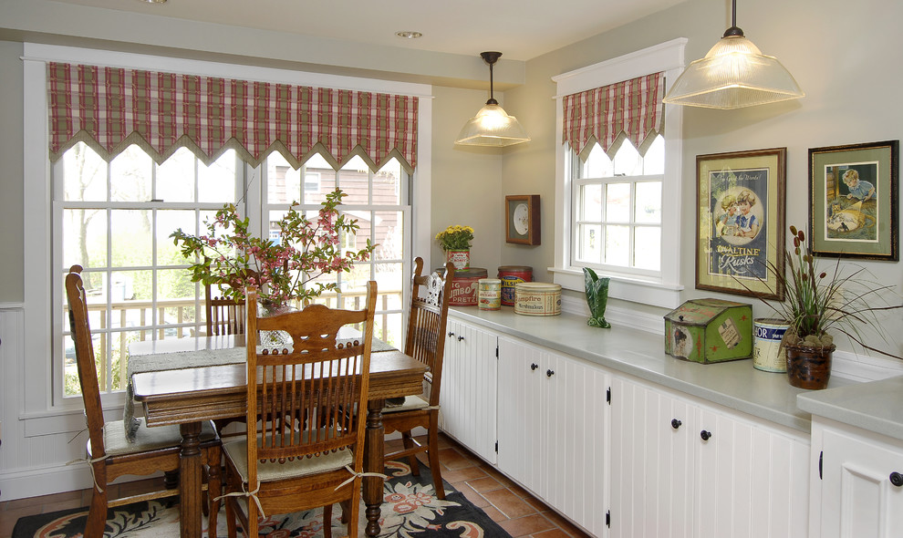 This is an example of a small country single-wall eat-in kitchen in Bridgeport with a drop-in sink, louvered cabinets, white cabinets and ceramic floors.