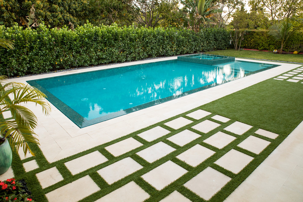 This is an example of a large modern backyard rectangular lap pool in Miami.