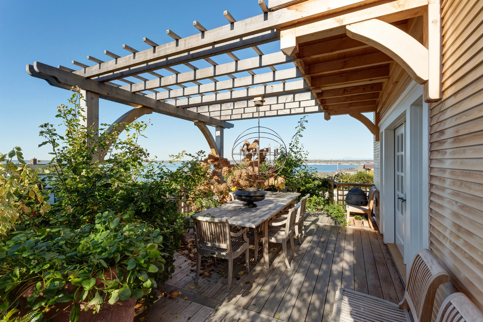 Inspiration for a beach style deck in Seattle with a pergola.
