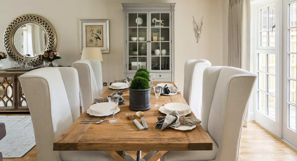 Photo of a country dining room in Berkshire with beige walls and light hardwood floors.