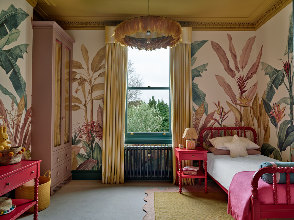 This is an example of a large traditional kids' bedroom for girls in London with carpet and wallpapered walls.