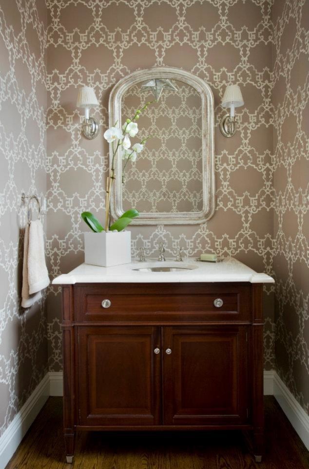 Design ideas for a small traditional powder room with raised-panel cabinets, dark wood cabinets, brown walls, dark hardwood floors, an undermount sink, engineered quartz benchtops and brown floor.