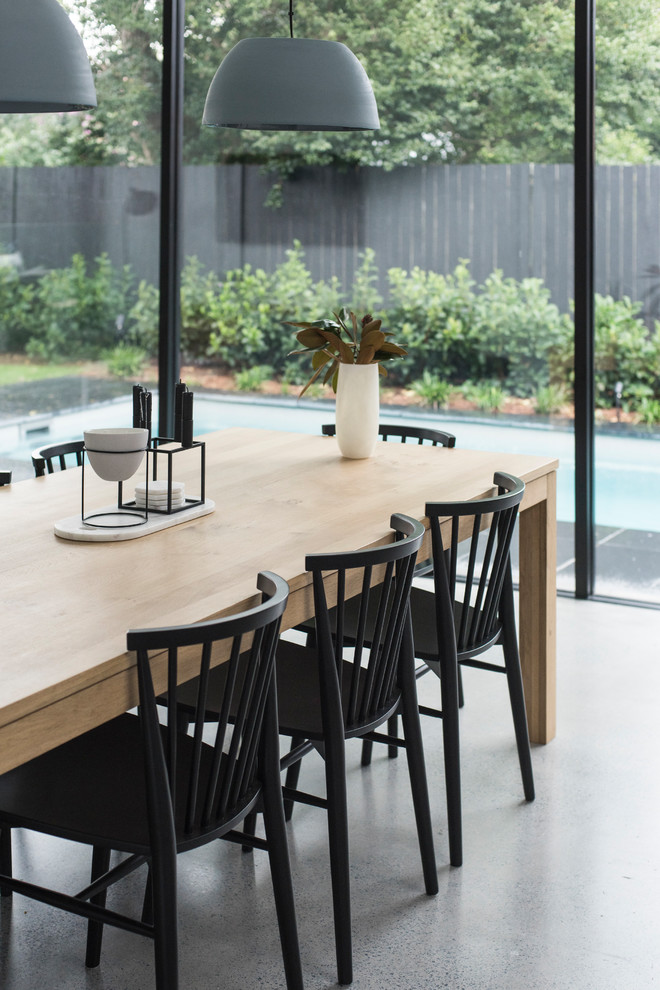 Photo of a large modern kitchen/dining combo in Sydney with white walls, concrete floors and grey floor.