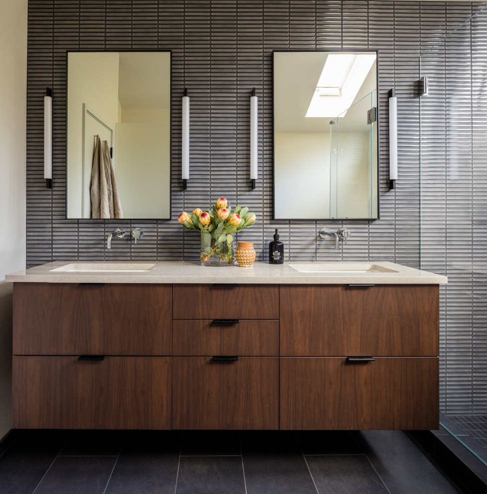 This is an example of a contemporary master bathroom in Seattle with flat-panel cabinets, dark wood cabinets, porcelain floors, an undermount sink, engineered quartz benchtops, grey floor, a double vanity, a floating vanity, gray tile, matchstick tile, grey walls and beige benchtops.
