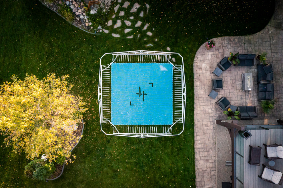 Design ideas for a large modern partial sun backyard outdoor basketball/tennis/multi-game court for summer.