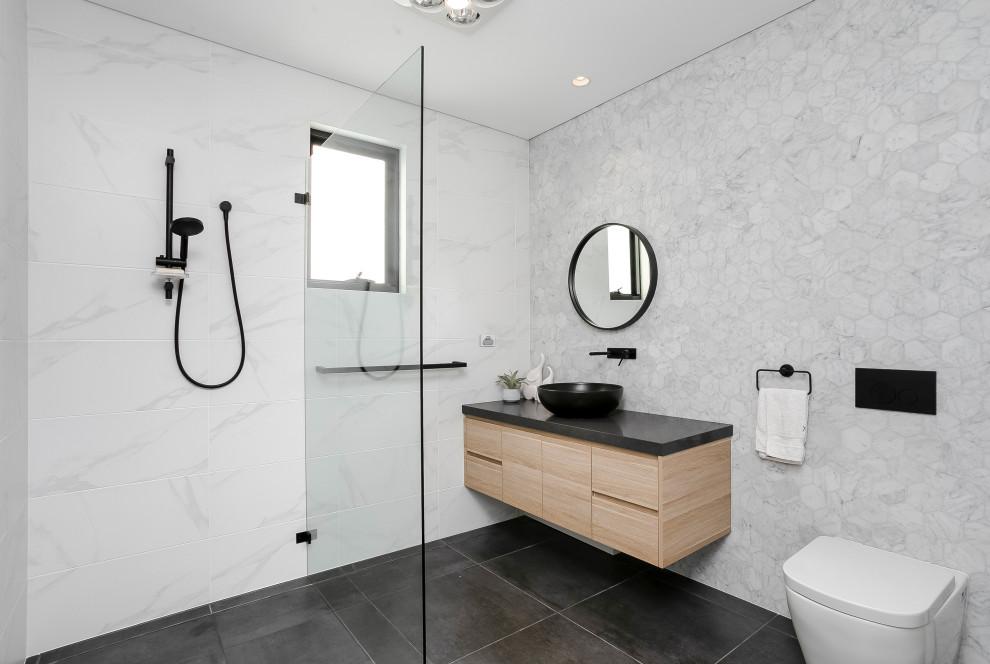 Photo of a mid-sized contemporary bathroom in Sydney with light wood cabinets, a two-piece toilet, black and white tile, marble, ceramic floors, a pedestal sink, engineered quartz benchtops, black floor, black benchtops, an open shower and an open shower.